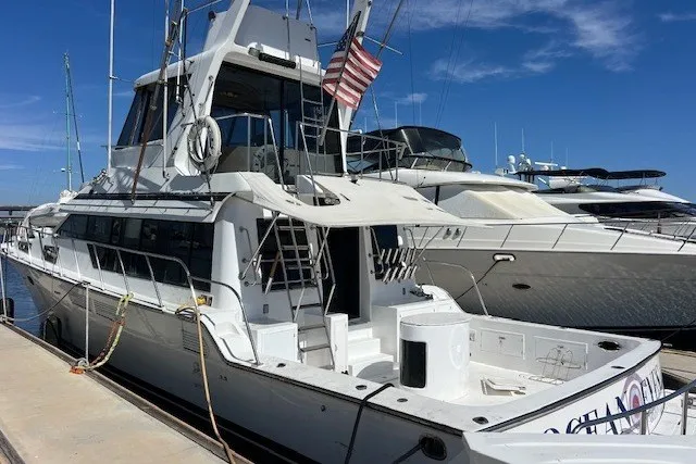 Slide: The Image of 1994 Mikelson 64 yacht docked at marina under clear blue sky. - 32