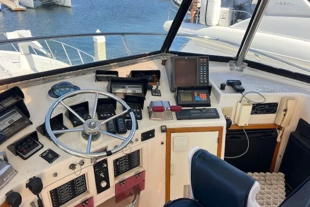 Slide: The Image of Cockpit of a 1994 Mikelson 64 yacht with navigation equipment and steering wheel. - 61
