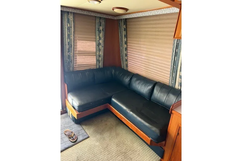 Slide: The Image of Luxurious black leather sofa in a 1994 Mikelson 64 yacht interior. - 49