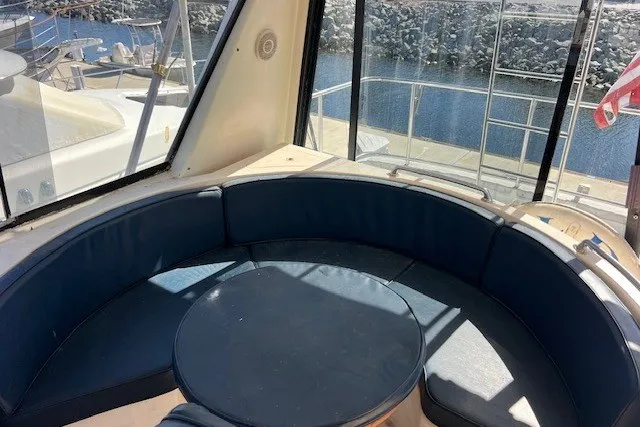 Slide: The Image of Cozy seating area on a 1994 Mikelson 64 yacht, overlooking marina. - 62