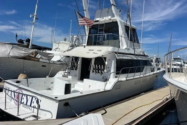 Slide: The Image of 1994 Mikelson 64 yacht docked at marina under clear blue sky. - 34
