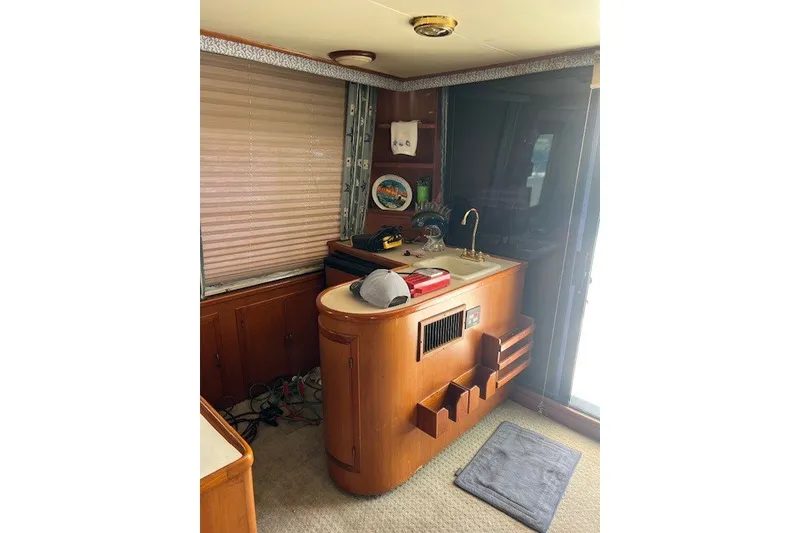 Slide: The Image of Interior of a 1994 Mikelson 64 yacht featuring a wooden counter and sink area. - 48