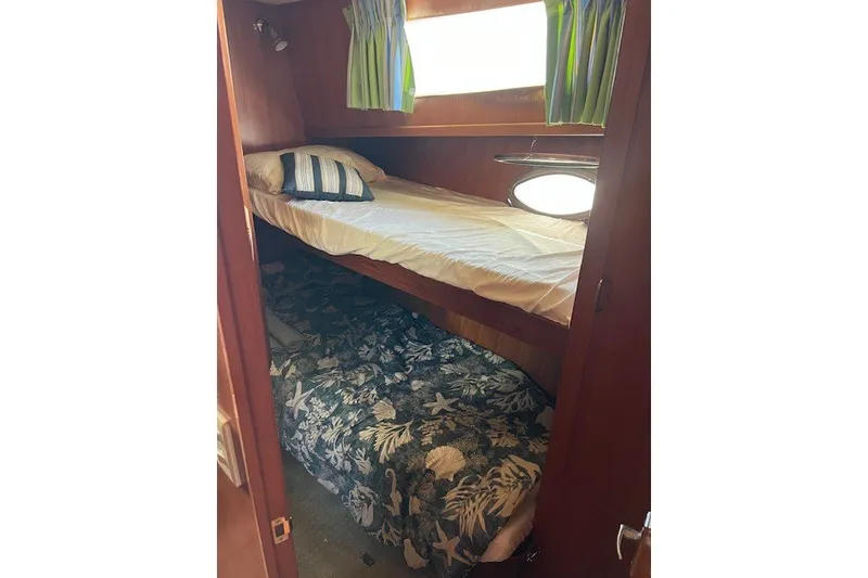 Slide: The Image of Cozy cabin with bunk beds in a 1994 Mikelson 64 yacht. - 53