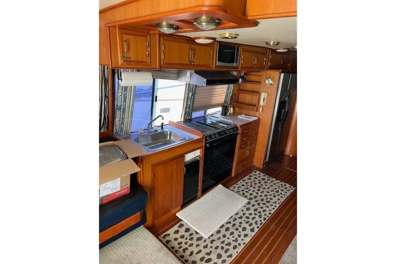 Slide: The Image of Interior of 1994 Mikelson 64 yacht kitchen with wooden cabinets and modern appliances. - 45