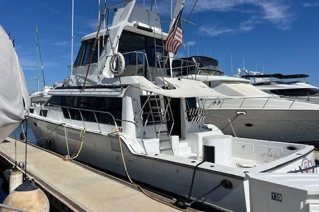 Slide: The Image of 1994 Mikelson 64 yacht docked at marina under clear blue sky. - 33