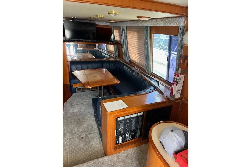 Slide: The Image of Interior of a 1994 Mikelson 64 yacht with seating, table, and control panel. - 44