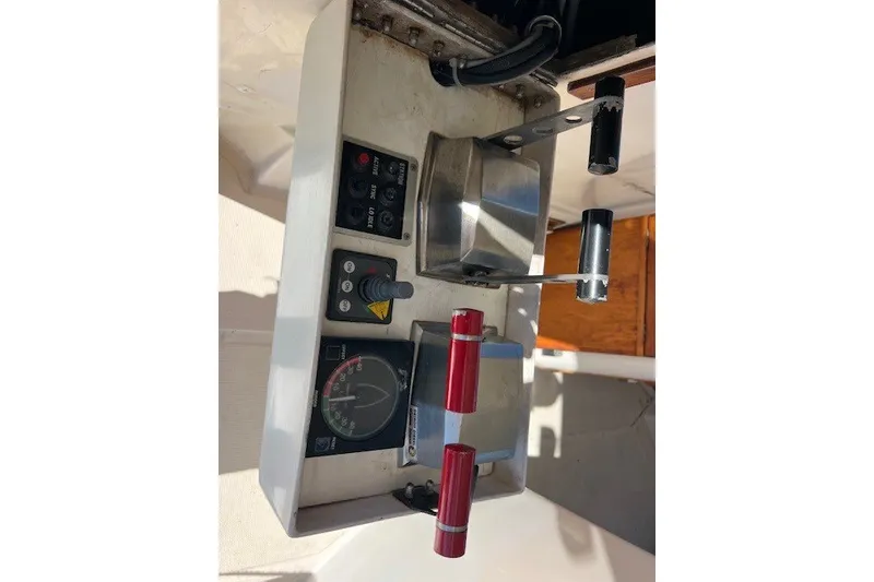 Slide: The Image of Control panel of a 1994 Mikelson 64 yacht with levers and gauges. - 64