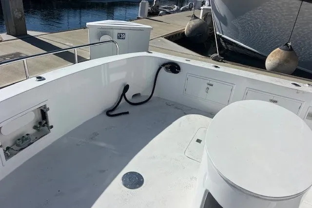 Slide: The Image of 1994 Mikelson 64 yacht deck with storage compartments and dock view. - 71