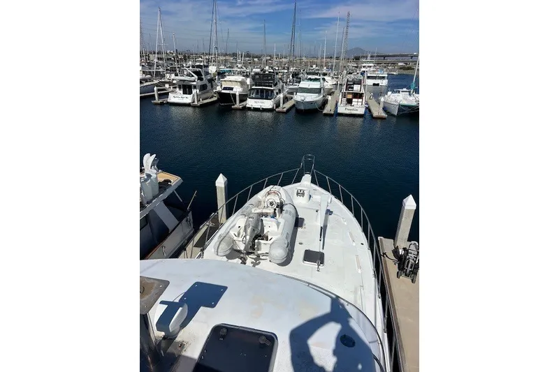 Slide: The Image of Mikelson 64 yacht from 1994 docked in a marina with other boats. - 66
