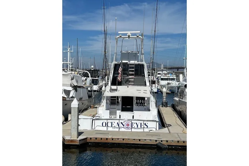 Slide: The Image of 1994 Mikelson 64 yacht docked at marina, featuring "Ocean Eyes" name on stern. - 29