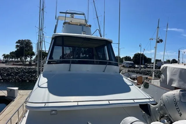 Slide: The Image of 1994 Mikelson 64 yacht docked at marina under clear blue sky. - 40