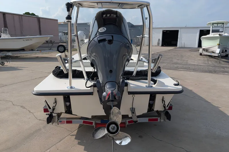 Slide: The Image of 2021 Maverick 18 HPX-V boat with outboard motor, parked on a trailer. - 25