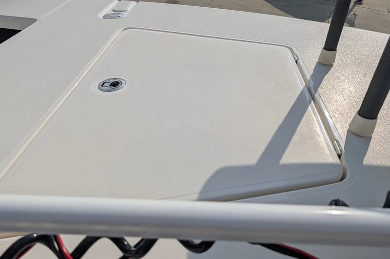Slide: The Image of 2021 Maverick 18 HPX-V boat deck with storage compartment and railing. - 20