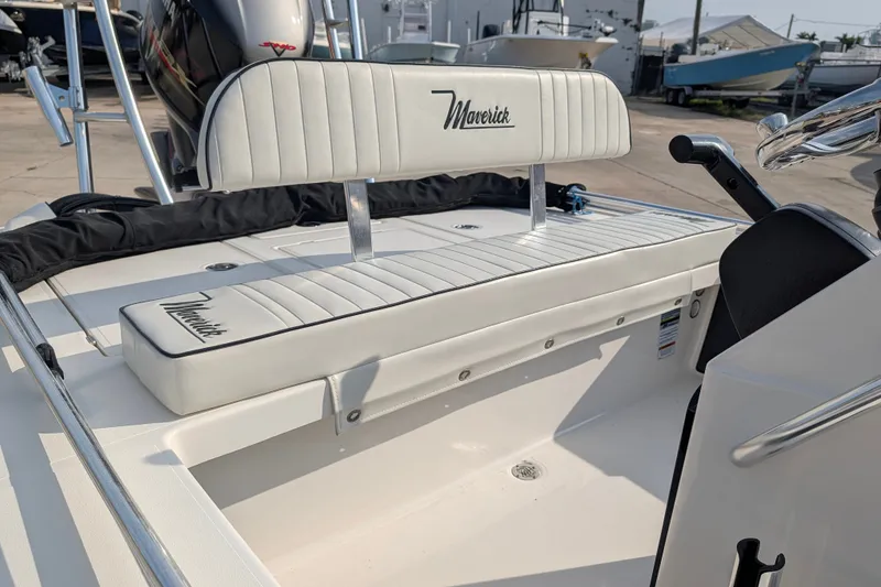 Slide: The Image of 2021 Maverick 18 HPX-V boat interior with white cushioned seating and steering console. - 13