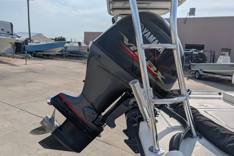 Slide: The Image of 2021 Maverick 18 HPX-V with Yamaha VMAX outboard motor in a boatyard setting. - 24