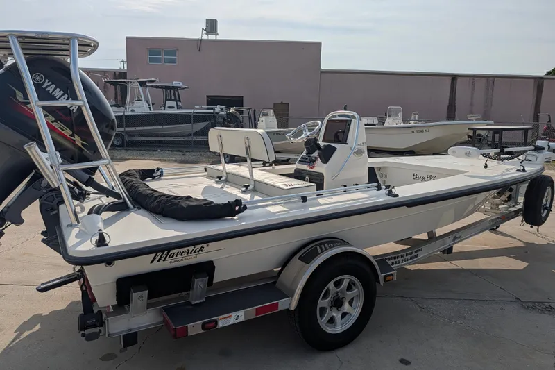 Slide: The Image of 2021 Maverick 18 HPX-V boat on trailer, parked outdoors near other boats. - 8