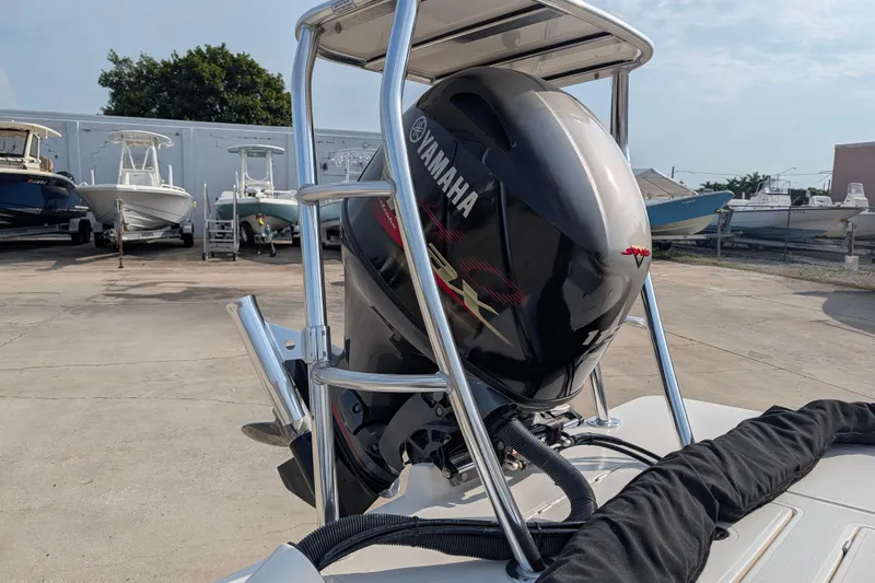 Slide: The Image of 2021 Maverick 18 HPX-V boat with Yamaha outboard motor in a marina setting. - 23