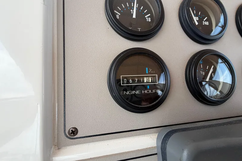 Slide: The Image of Close-up of Carver 380 Santego 1999 engine hour gauge showing 672 hours. - 19