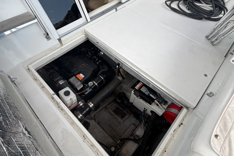 Slide: The Image of Engine compartment of a 1999 Carver 380 Santego boat, showcasing mechanical components. - 48