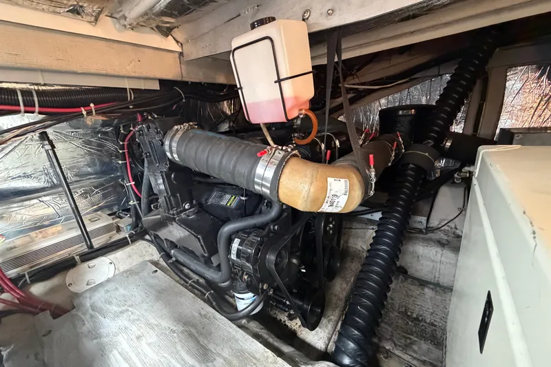 Slide: The Image of Engine room of a 1999 Carver 380 Santego boat, showcasing mechanical components. - 49