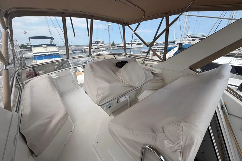 Slide: The Image of 1999 Carver 380 Santego yacht interior with covered seating at marina. - 16
