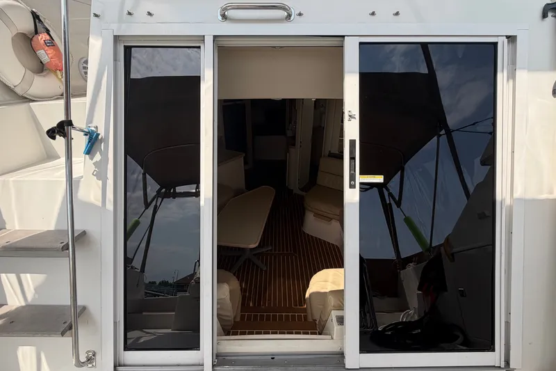 Slide: The Image of 1999 Carver 380 Santego yacht interior view through sliding glass doors. - 31