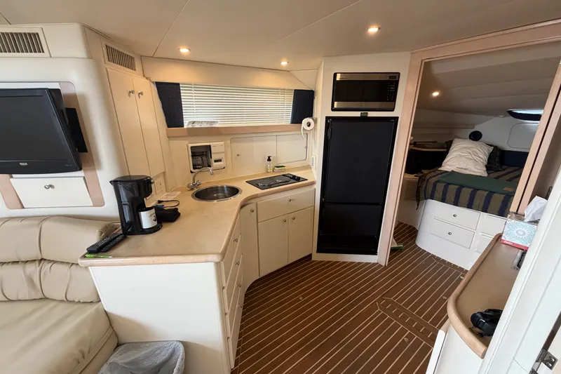 Slide: The Image of Interior of 1999 Carver 380 Santego yacht with kitchenette and cozy sleeping area. - 37