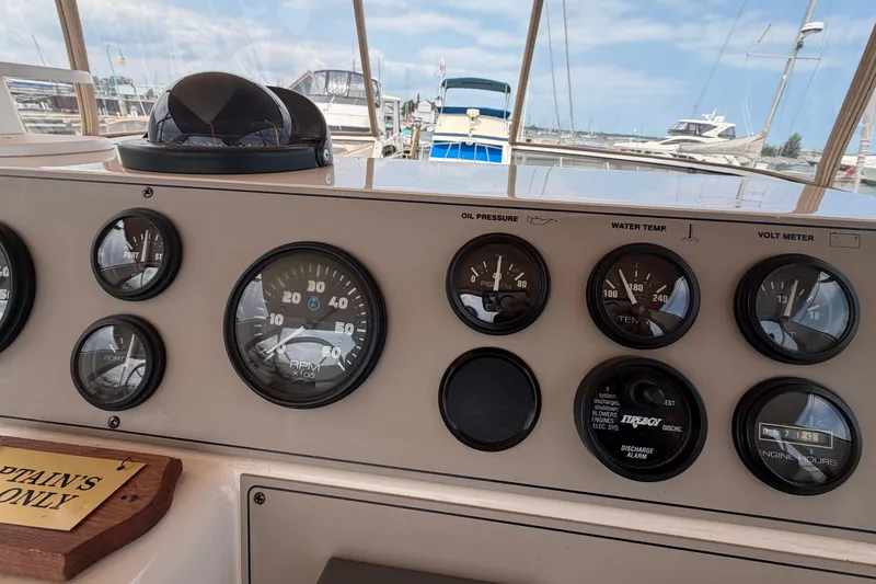 Slide: The Image of Dashboard of a 1999 Carver 380 Santego boat with gauges and controls. - 22
