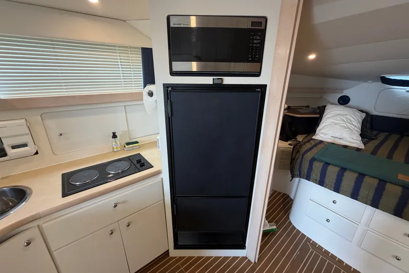 Slide: The Image of Interior of a 1999 Carver 380 Santego yacht with kitchen and sleeping area. - 39