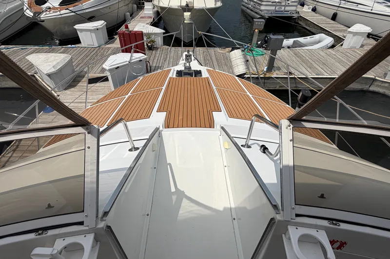 Slide: The Image of 1999 Carver 380 Santego yacht docked at marina, featuring sleek wooden deck design. - 27