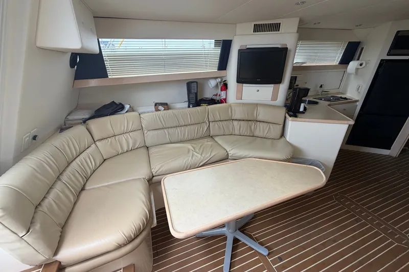 Slide: The Image of Interior of 1999 Carver 380 Santego yacht with leather seating and kitchenette. - 33