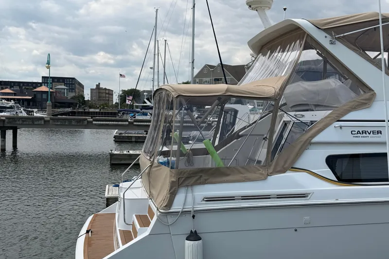 Slide: The Image of 1999 Carver 380 Santego yacht docked at a marina under cloudy skies. - 4