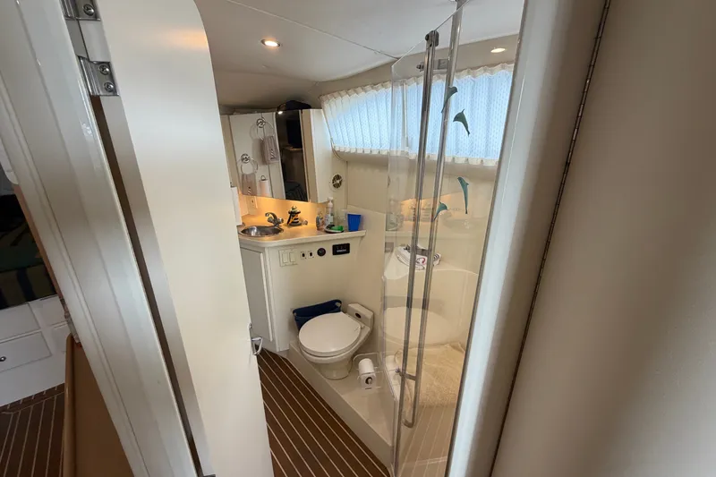 Slide: The Image of Bathroom interior of 1999 Carver 380 Santego yacht, featuring shower and sink. - 42