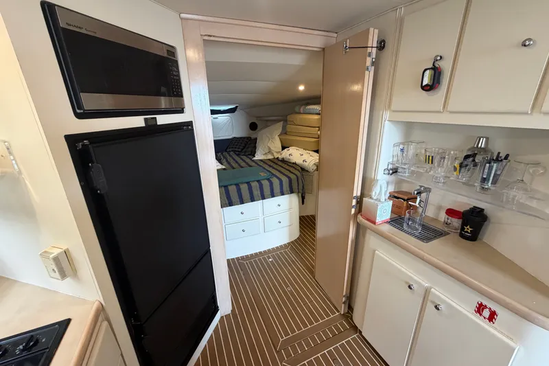 Slide: The Image of Interior of 1999 Carver 380 Santego yacht with kitchenette and cozy sleeping area. - 40
