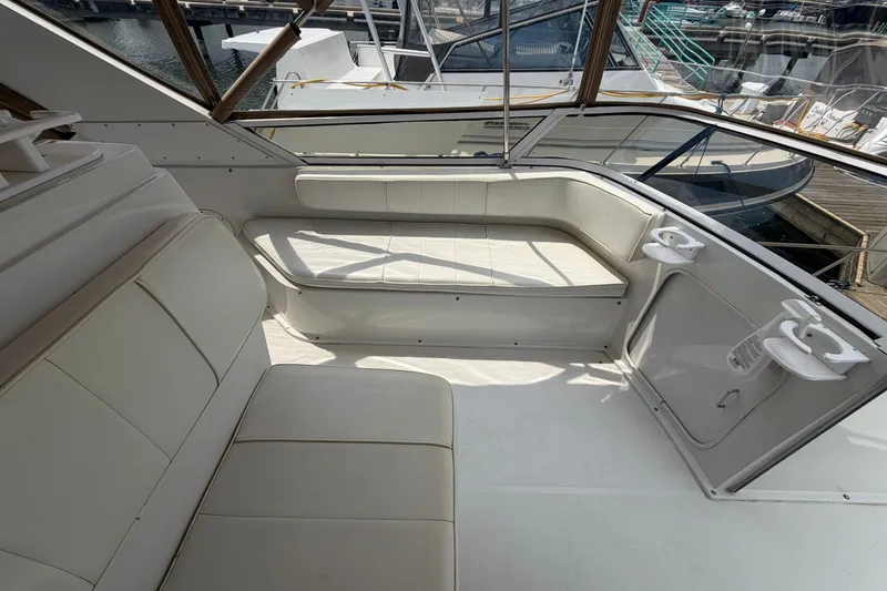 Slide: The Image of 1999 Carver 380 Santego yacht interior with white seating and cup holders. - 26