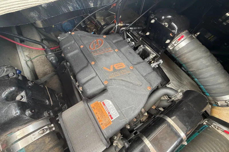 Slide: The Image of Engine compartment of a 1999 Carver 380 Santego boat, featuring a V8 engine. - 50