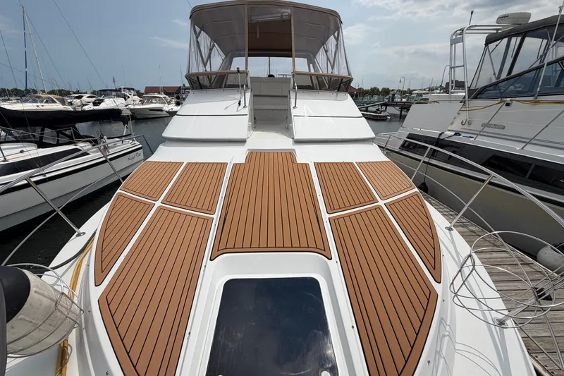 Slide: The Image of 1999 Carver 380 Santego yacht with sleek deck design, docked in a marina. - 29
