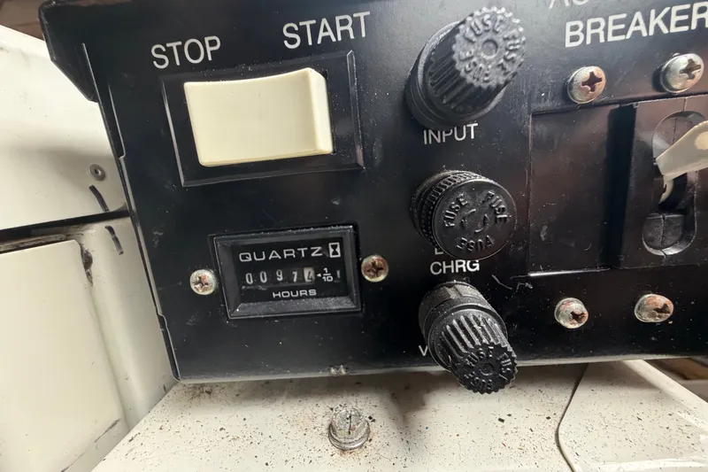 Slide: The Image of Control panel of a 1999 Carver 380 Santego with hour meter and switches. - 53