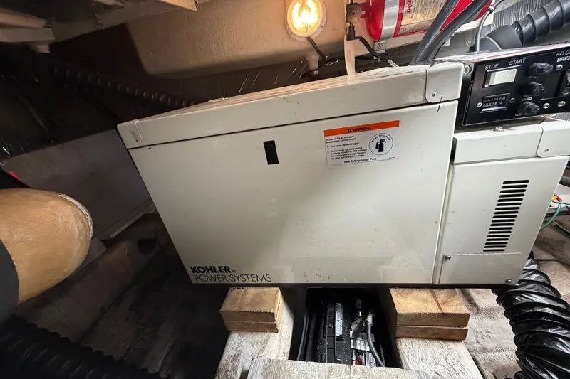 Slide: The Image of Kohler power system in 1999 Carver 380 Santego boat engine room, with fire extinguisher. - 52