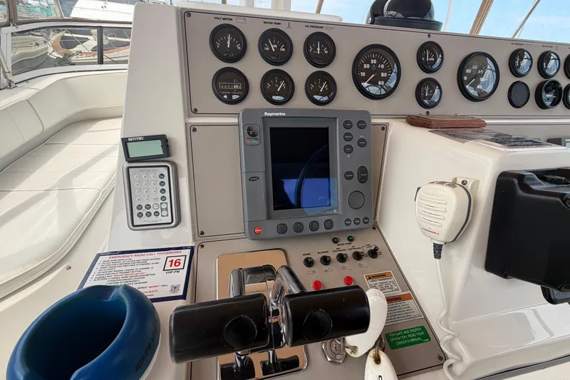 Slide: The Image of Control panel of a 1999 Carver 380 Santego yacht with gauges and navigation equipment. - 18