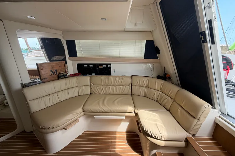 Slide: The Image of Interior of 1999 Carver 380 Santego yacht with beige leather seating and wooden flooring. - 35