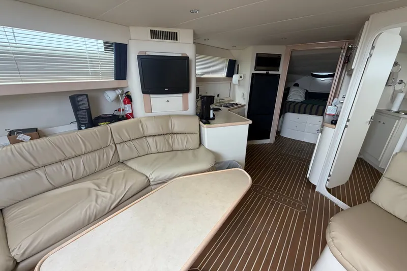 Slide: The Image of Interior of 1999 Carver 380 Santego yacht with beige seating and modern amenities. - 34
