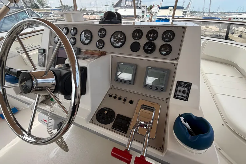 Slide: The Image of Control panel of a 1999 Carver 380 Santego yacht with steering wheel and gauges. - 20