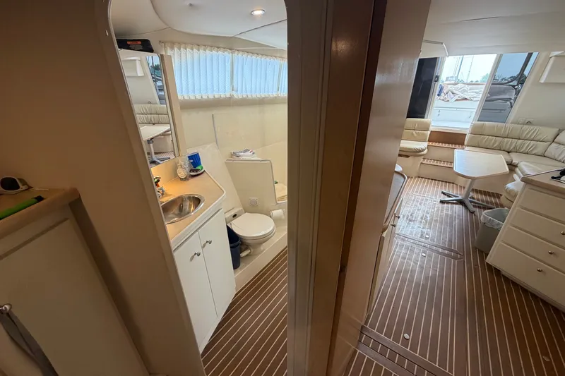Slide: The Image of Interior of 1999 Carver 380 Santego yacht with bathroom and seating area. - 47