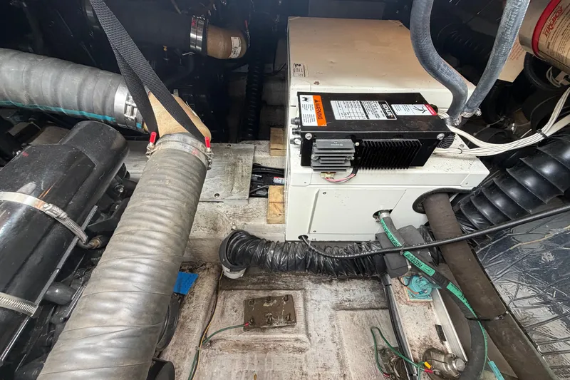 Slide: The Image of Engine compartment of a 1999 Carver 380 Santego boat, showing mechanical components and wiring. - 51
