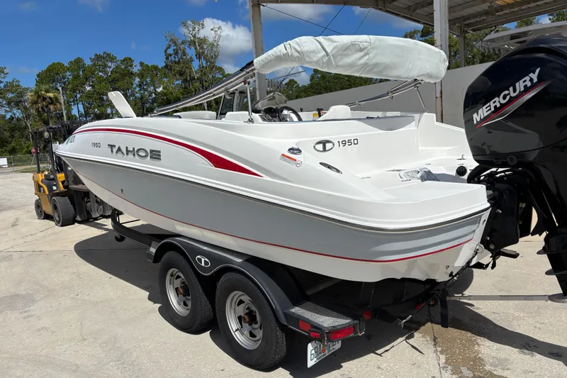 Slide: The Image of Tahoe 1950 boat from 2022 on trailer, featuring Mercury outboard motor. - 2