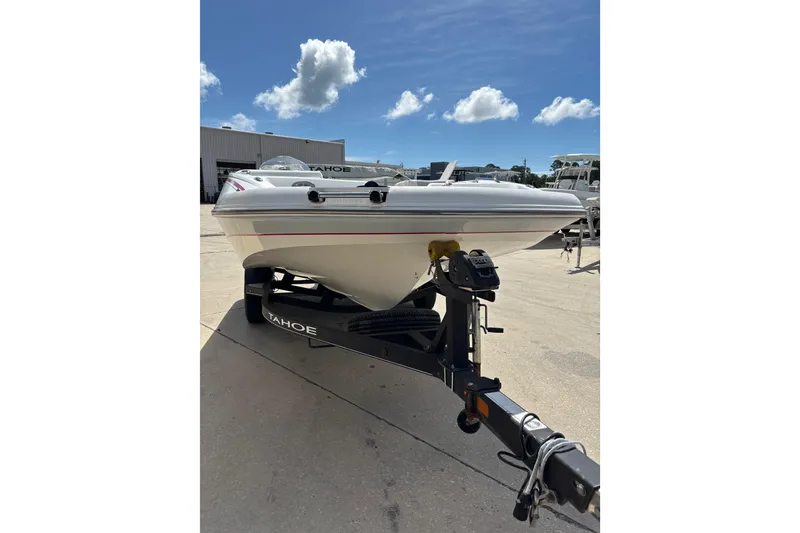 Slide: The Image of Tahoe 1950 boat on trailer, 2022 model, parked outdoors under a clear blue sky. - 3