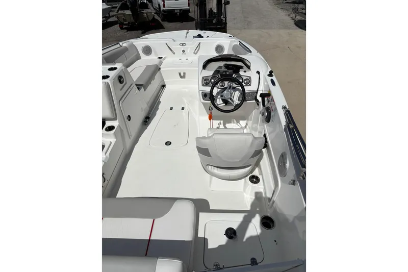 Slide: The Image of Interior view of a 2022 Tahoe 1950 boat, featuring a sleek white design and modern controls. - 5