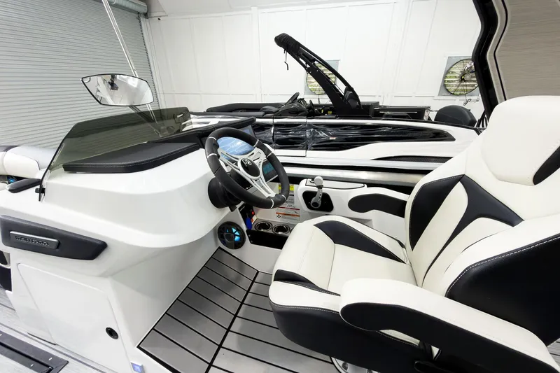 Slide: The Image of 2025 Montara Surf Boss 2.0 SL 25' boat interior with sleek steering and modern seating. - 10