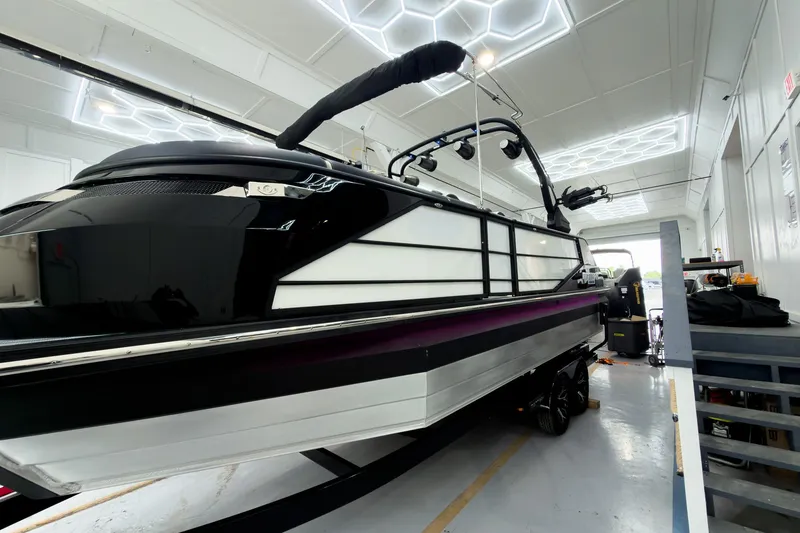 Slide: The Image of 2025 Montara Surf Boss 2.0 - SL 25' boat in a modern indoor facility. - 3
